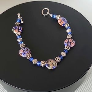 Vintage bracelet features flower lamp work glass beads, pewter daisies & more!